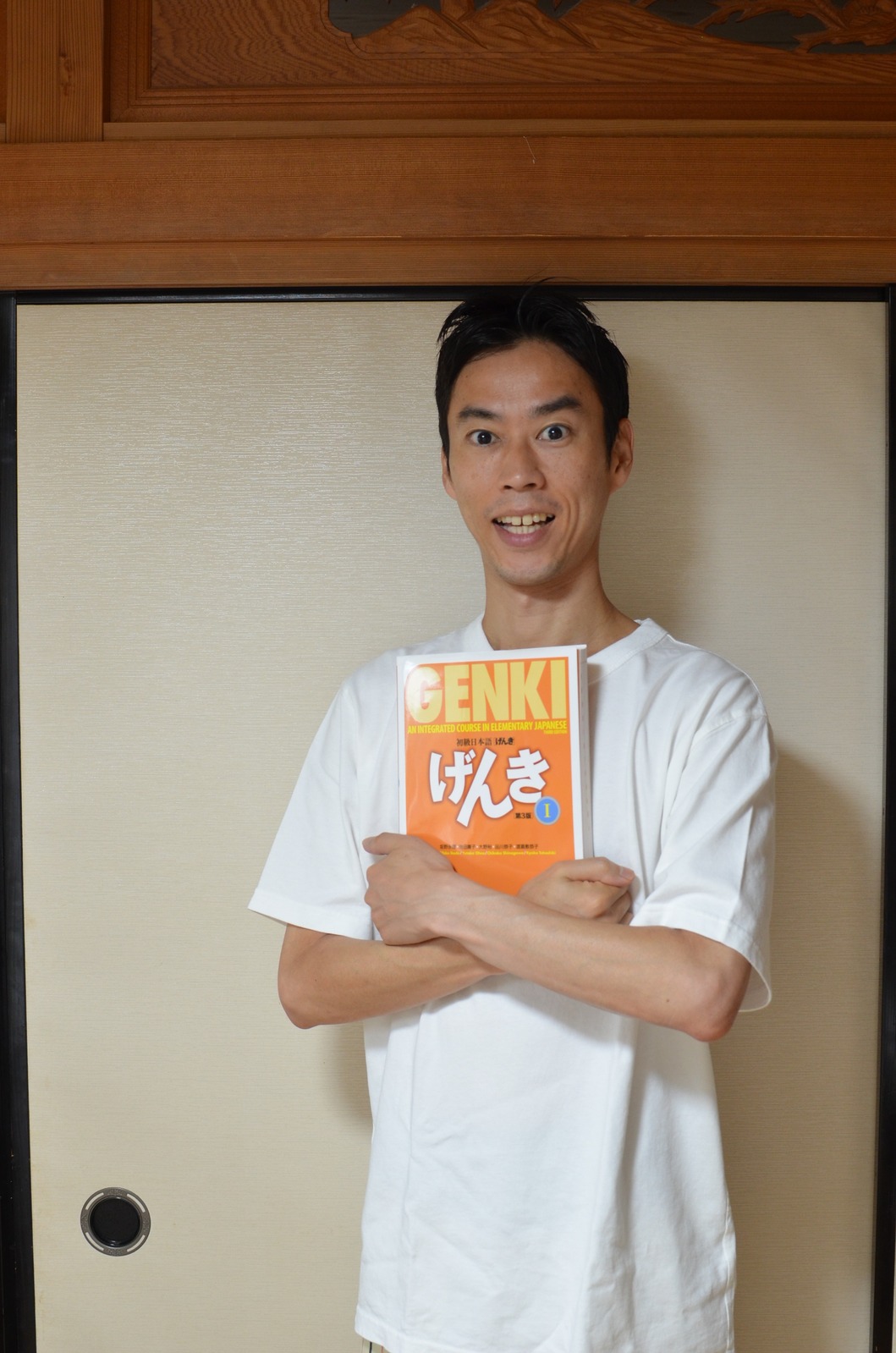 Yuya holding the GENKI textbook
